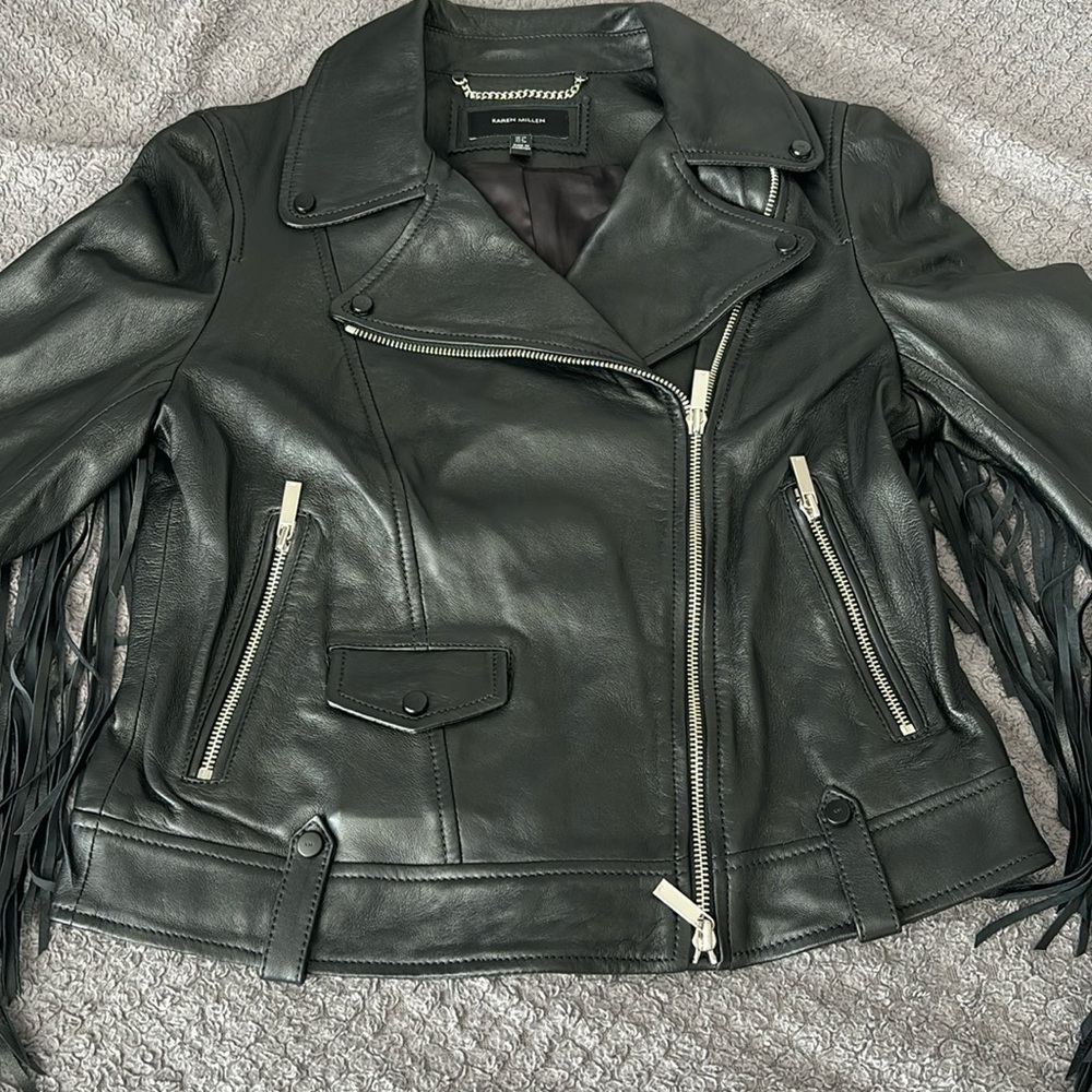black leather jacket with ruffles along the back and sleeves